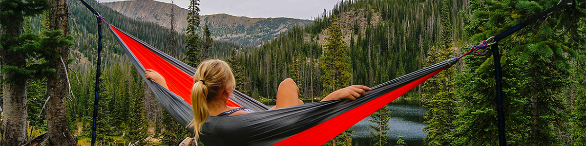 Woman in hammock looking out into mountains