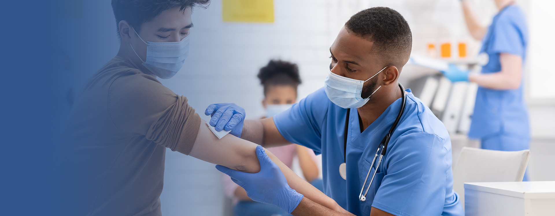 A male doctor preparing a male patient for injection