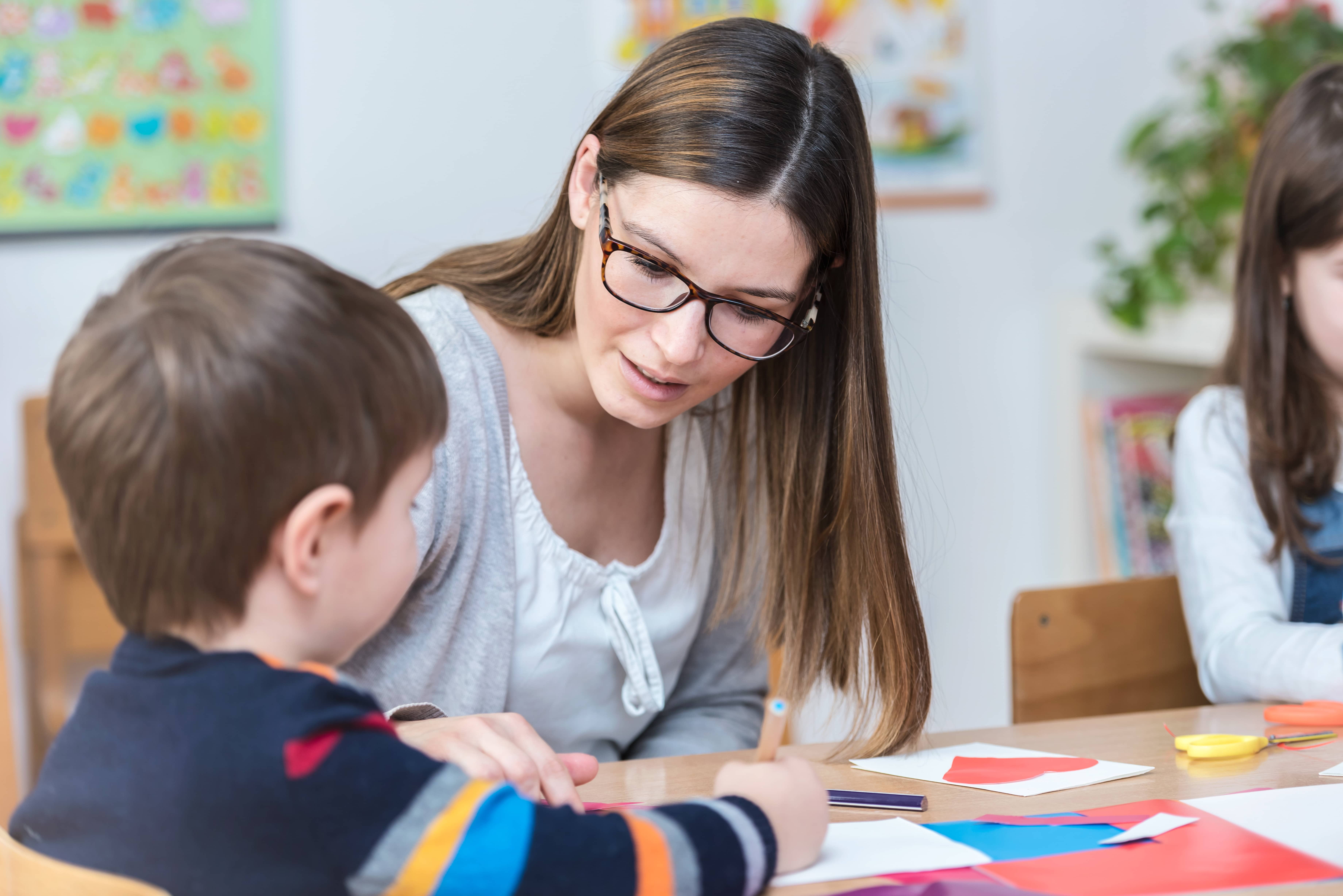 Woman therapist working with child Woman therapist working with child