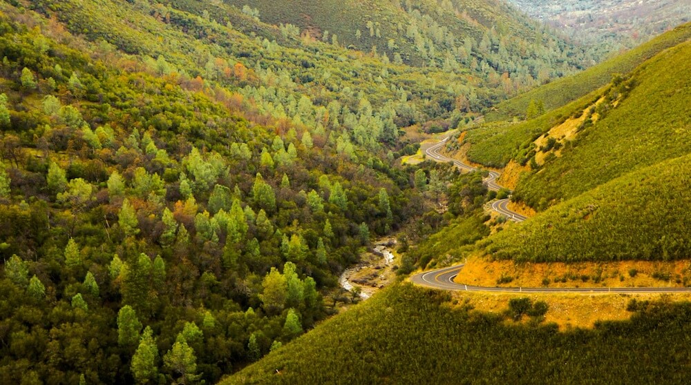 Road winding through green hillsides in California Road winding through green hillsides in California