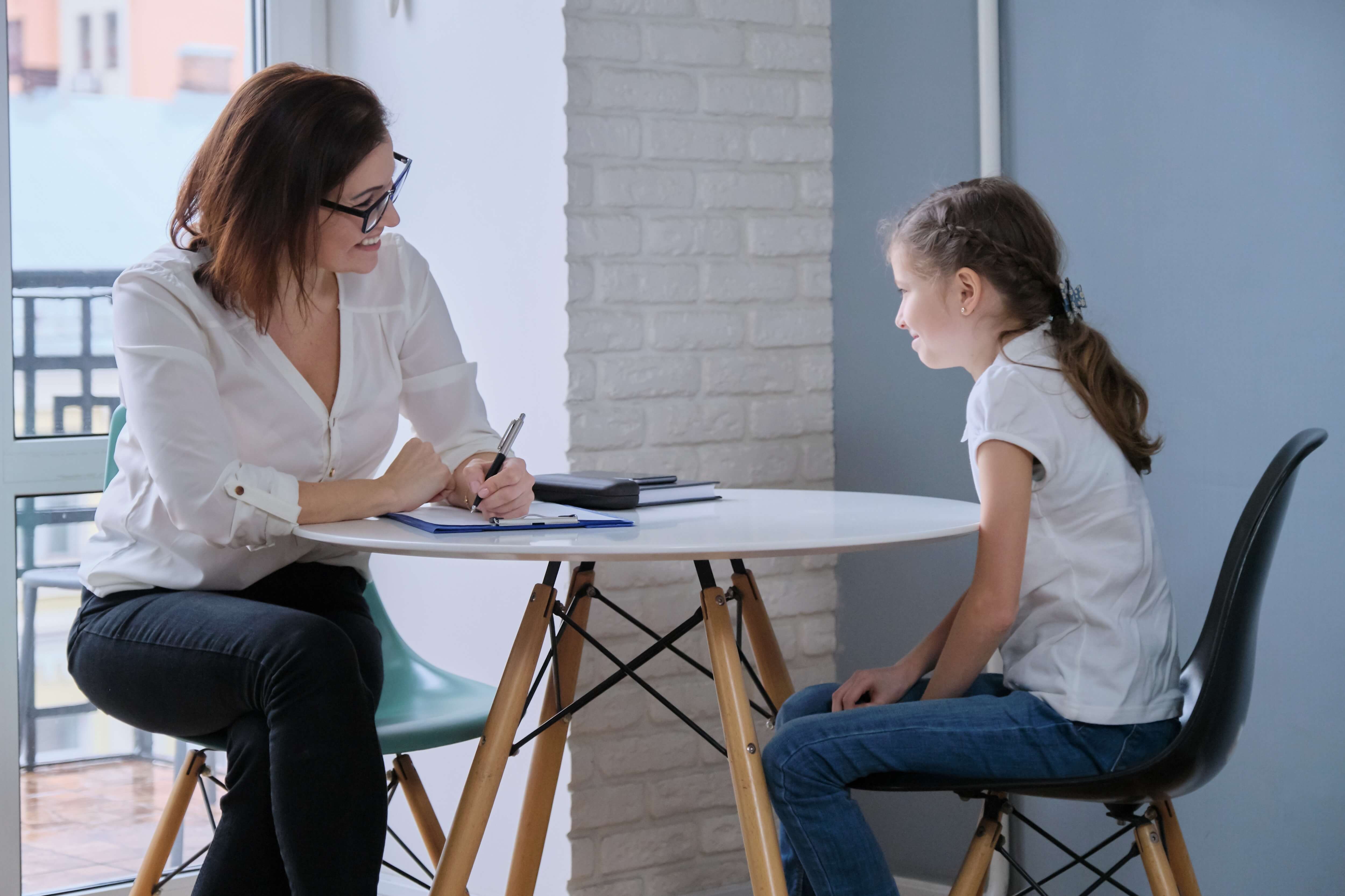 woman and child talking at round table woman and child talking at round table