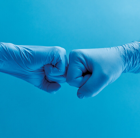 Two gloved hands bumping fists Two gloved hands bumping fists
