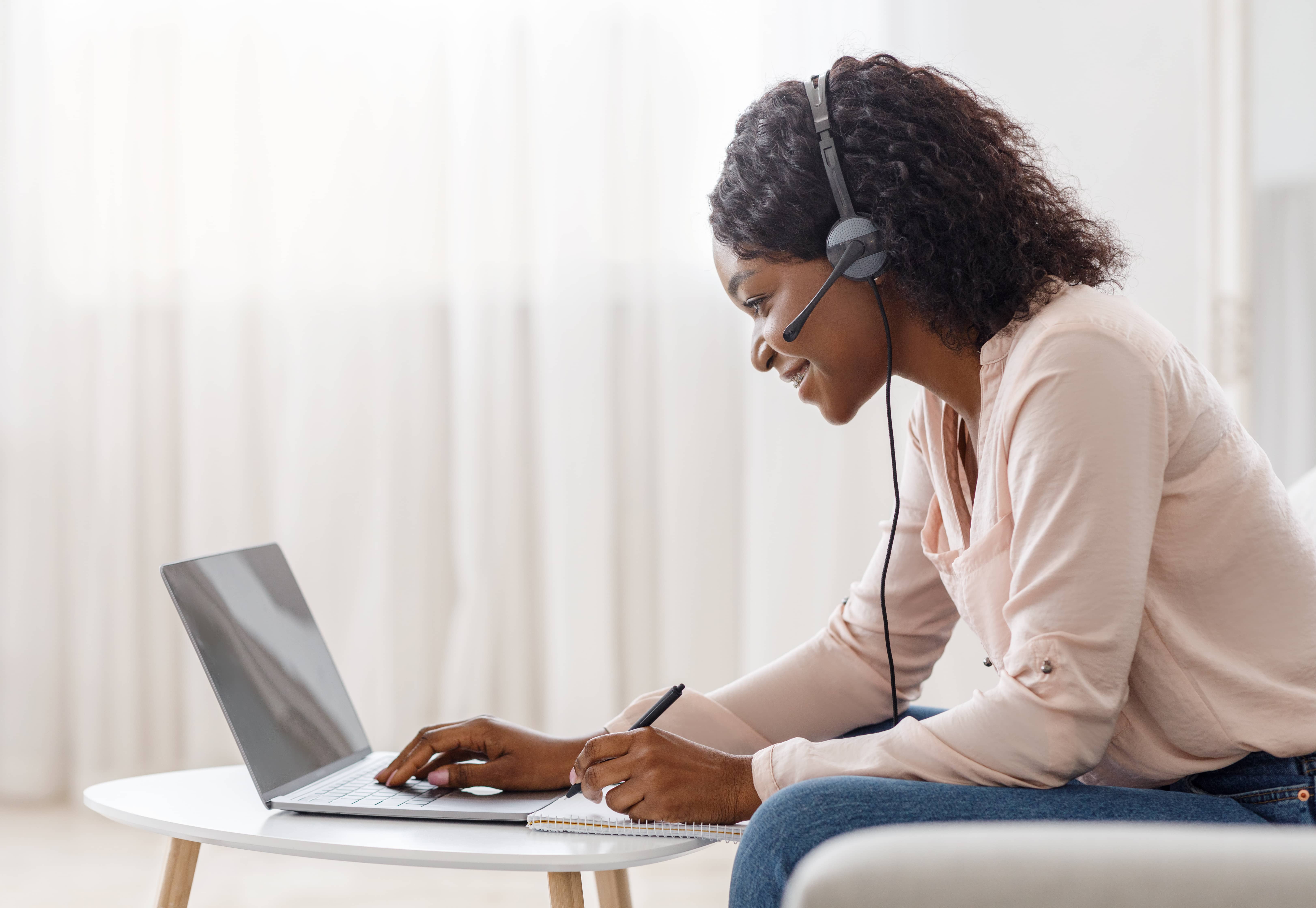 Woman leaning over laptop Woman leaning over laptop
