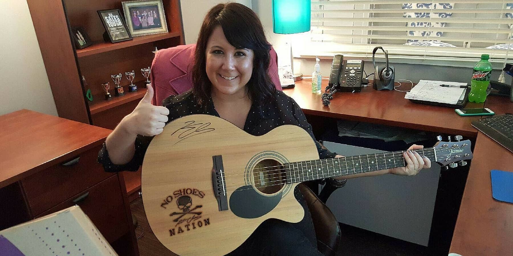 Amy Barnes gives thumbs up while holding guitar Amy Barnes gives thumbs up while holding guitar