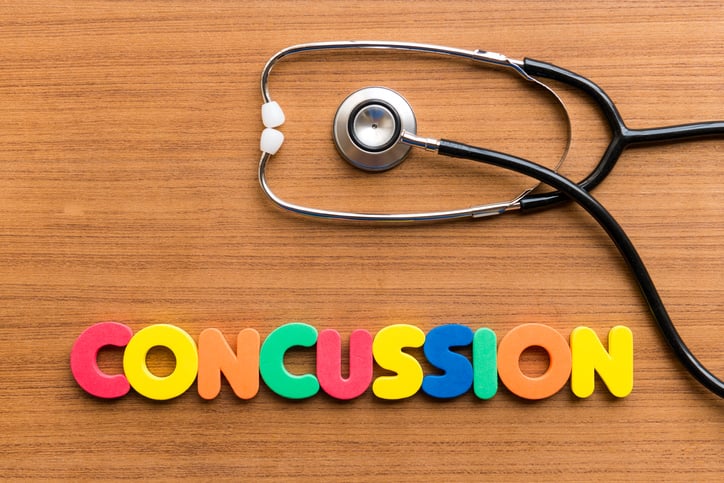 Word concussion spelled out in block letters with stethoscope above Word concussion spelled out in block letters with stethoscope above