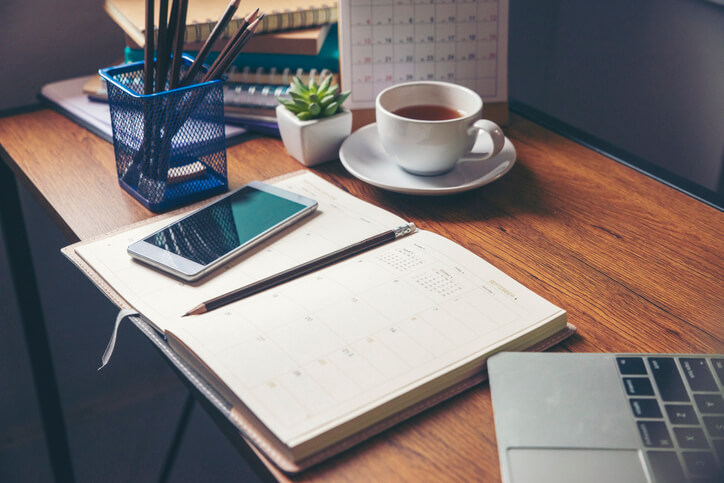 Coffee, planner, laptop and cellphone Coffee, planner, laptop and cellphone