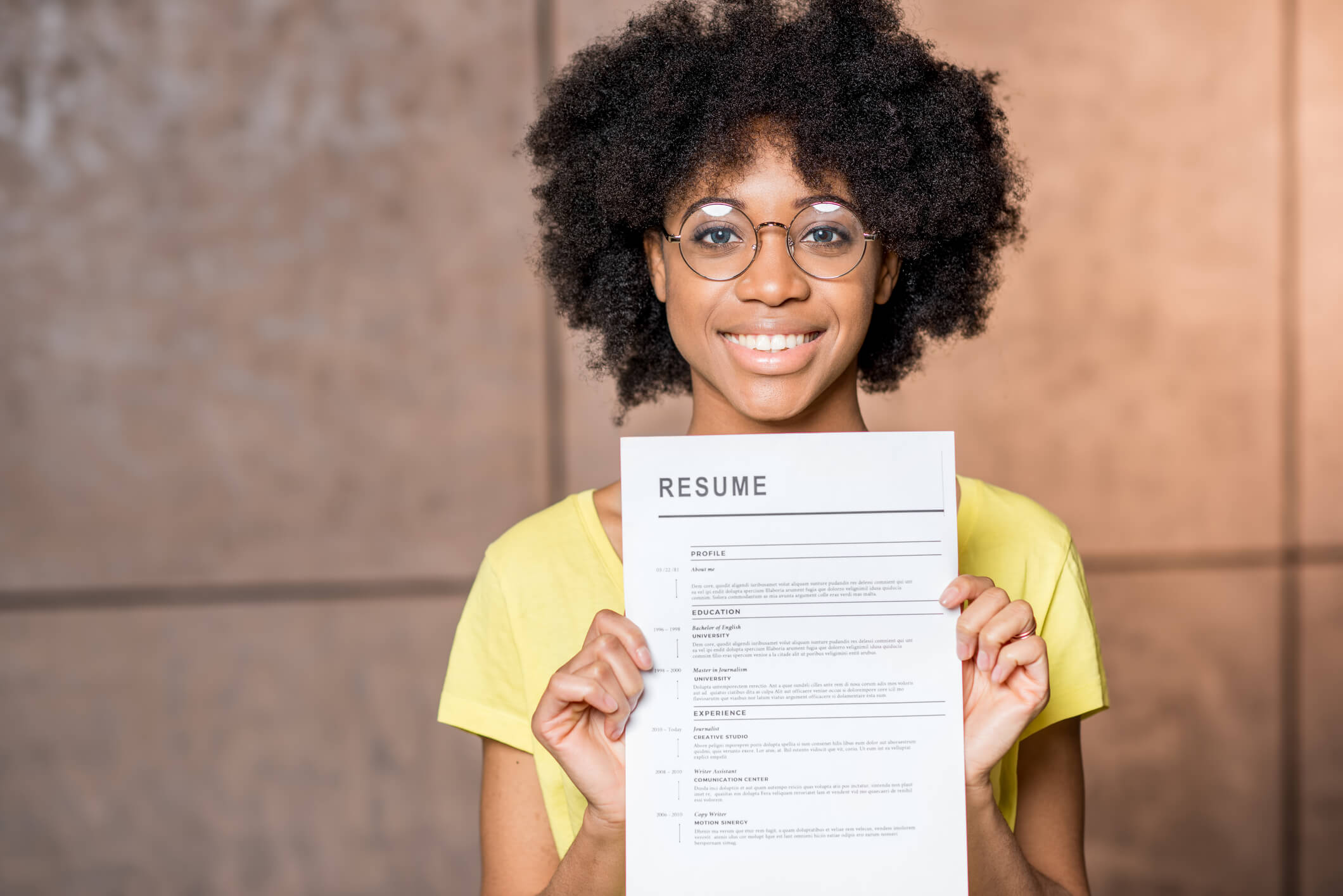 Resume held by smiling young woman Resume held by smiling young woman