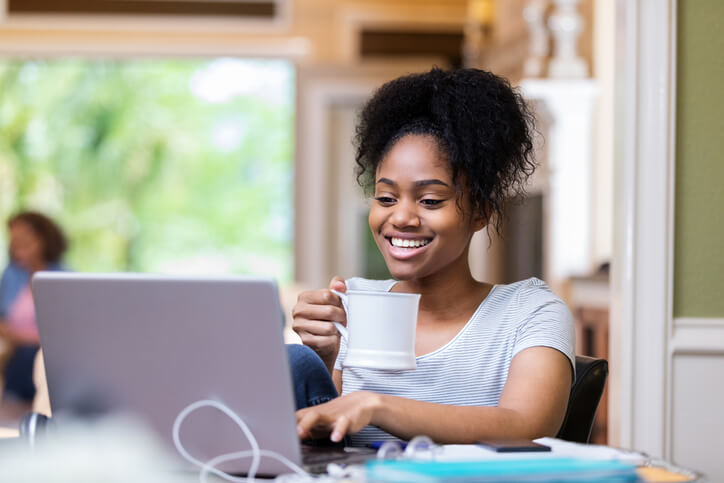 smiling woman with laptop and coffee smiling woman with laptop and coffee