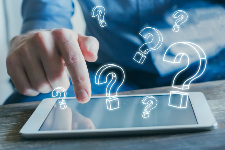 question marks floating above a tablet question marks floating above a tablet