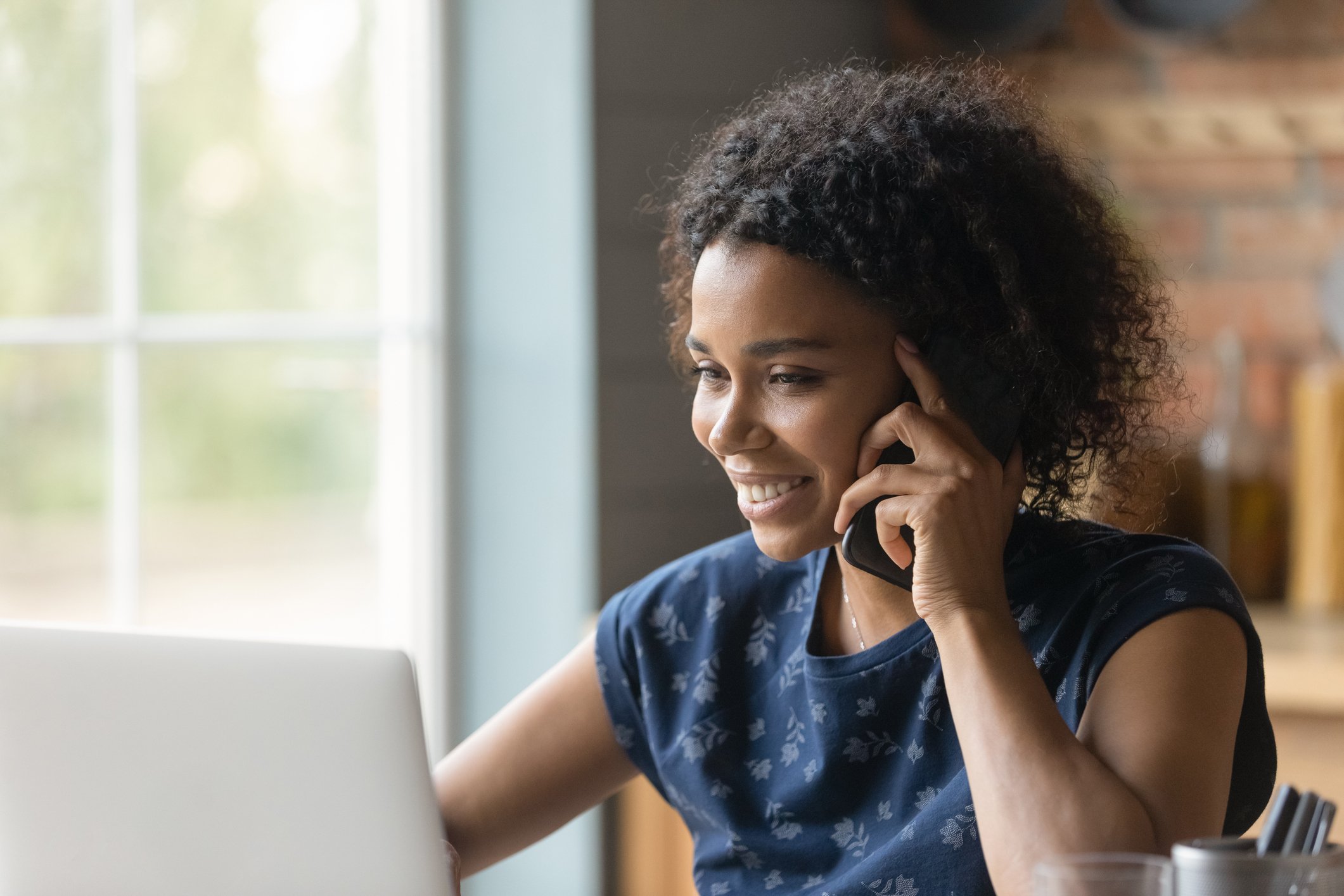 woman on phone in home office woman on phone in home office