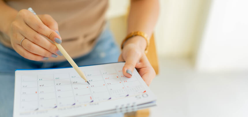 Woman consulting calendar Woman consulting calendar