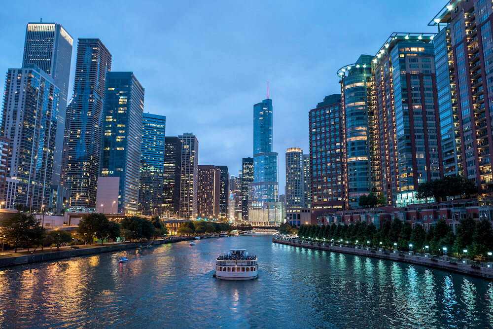 Chicago cityscape with buildings and river at night Chicago cityscape with buildings and river at night