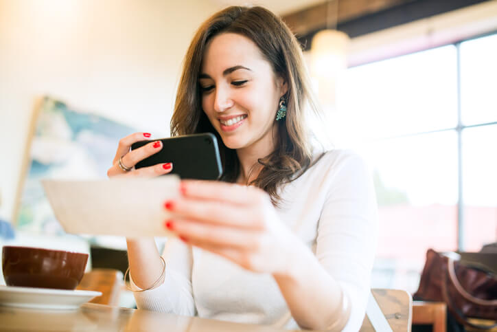 Woman making electronic deposit of check Woman making electronic deposit of check