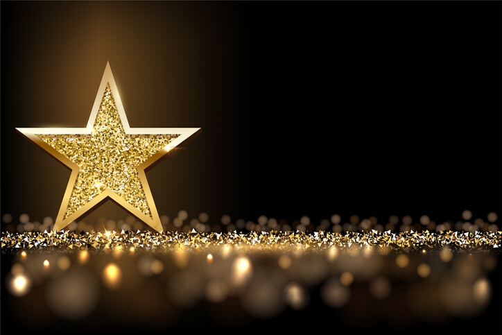 Gold glittery star on black background Gold glittery star on black background