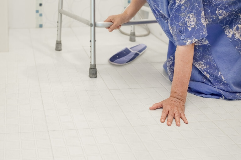 woman fallen on floor next to walker woman fallen on floor next to walker