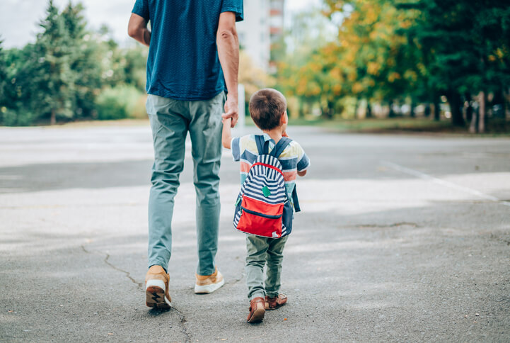 Father and kindergartner with backpack Father and kindergartner with backpack