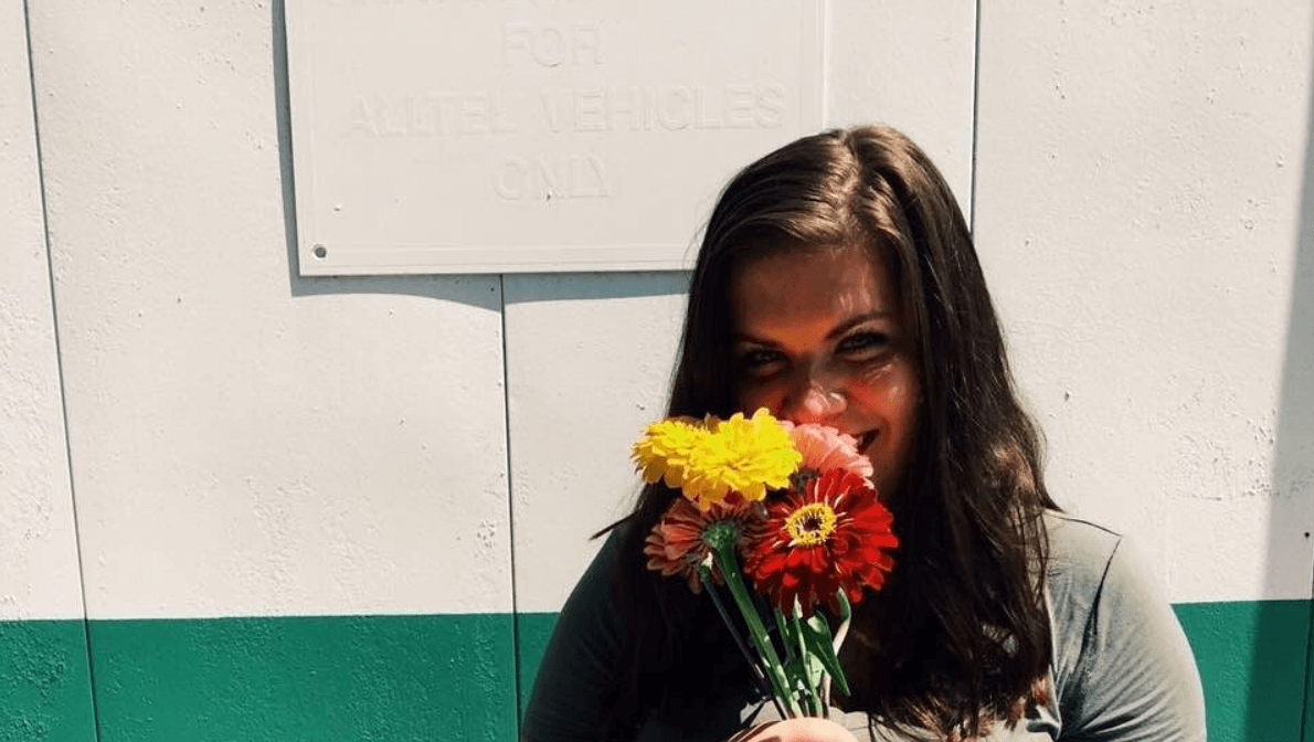 woman smelling bouquet of flowers woman smelling bouquet of flowers