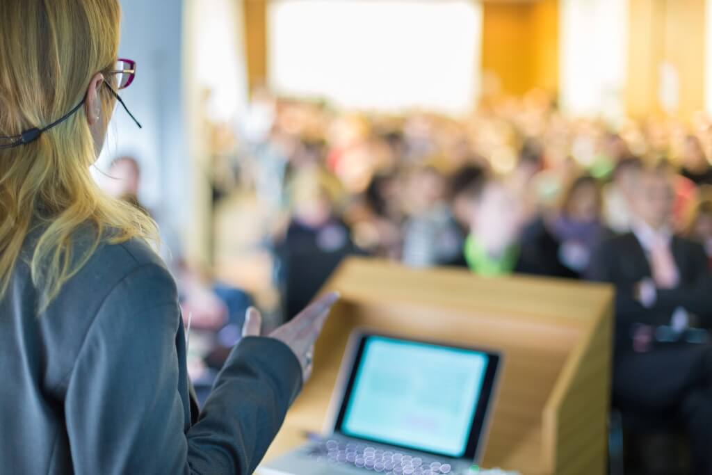 Woman speaking at conference Woman speaking at conference