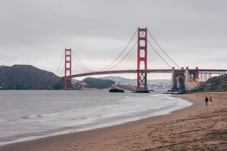 couple on beach near Golden Gate Bridge couple on beach near Golden Gate Bridge