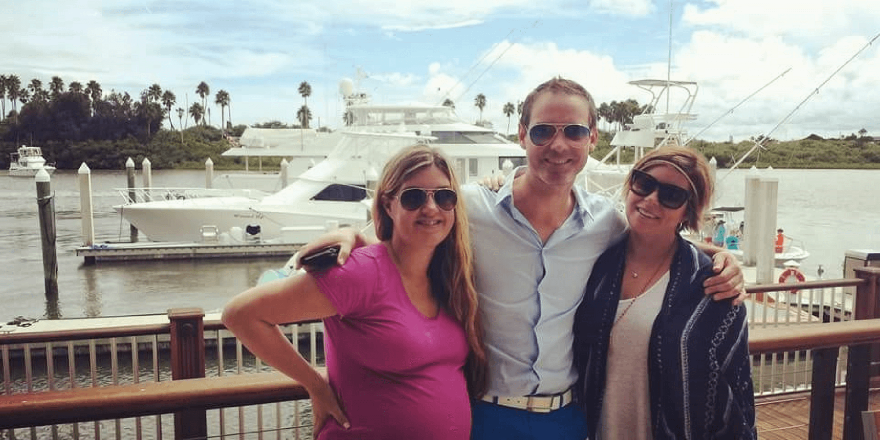 Jen Cross with two other adults standing in front of yacht Jen Cross with two other adults standing in front of yacht