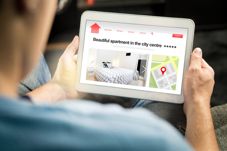 Man hunting apartment on tablet Man hunting apartment on tablet
