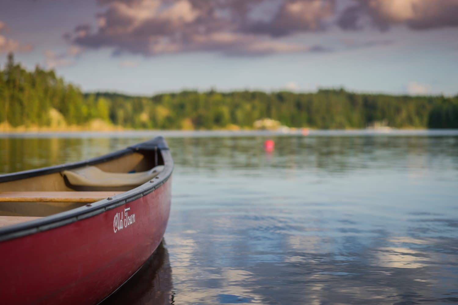 Canoe floating on peaceful lake Canoe floating on peaceful lake