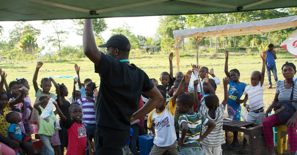 Group gathered raising hands in Haiti Group gathered raising hands in Haiti