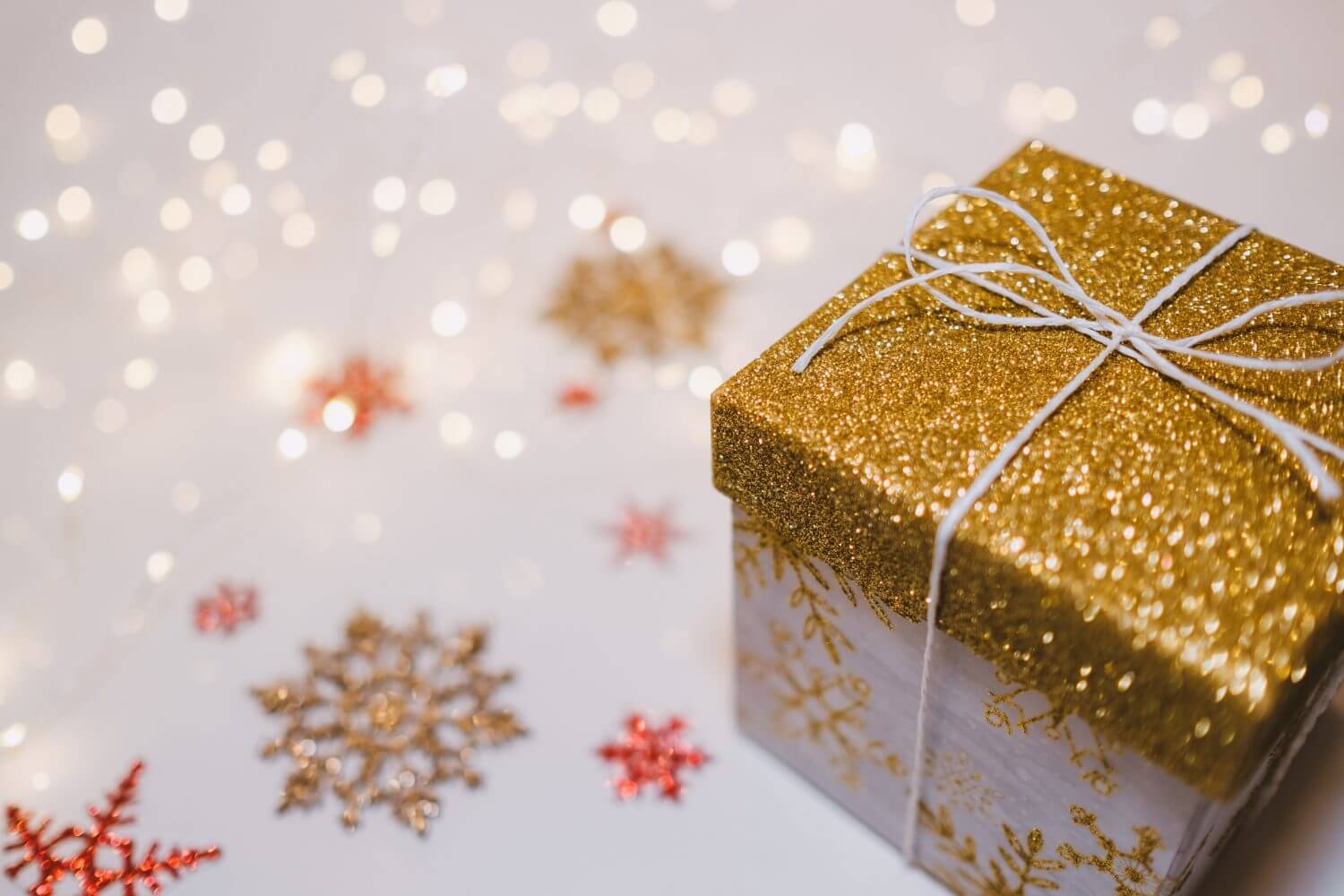 Glittery gift package on holiday background Glittery gift package on holiday background