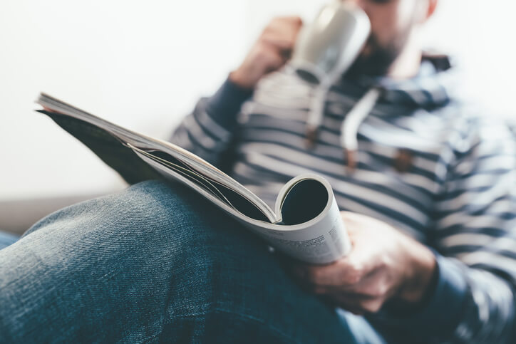 man relaxing reading magazine man relaxing reading magazine