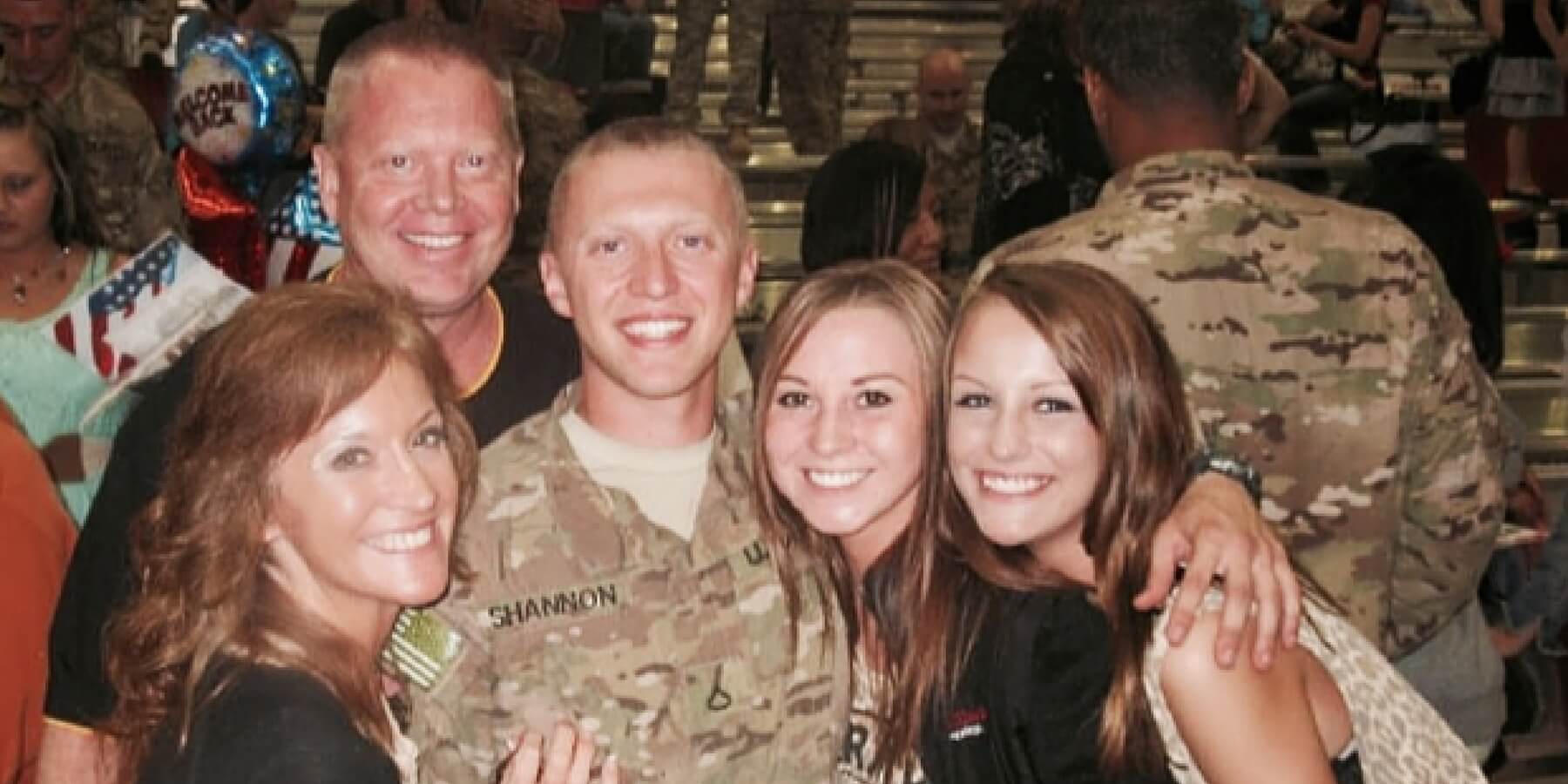 Military family smiling with arms around each other Military family smiling with arms around each other