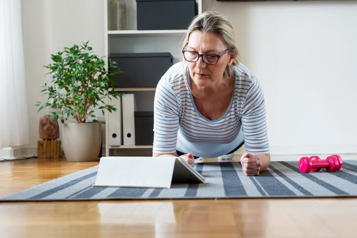 Older woman exercising at home Older woman exercising at home