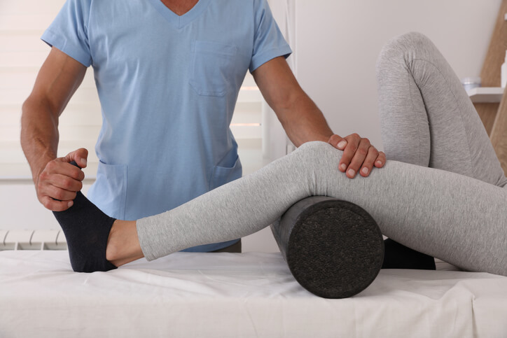 therapist doing physical therapy with patient therapist doing physical therapy with patient