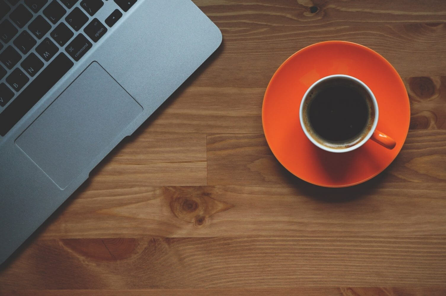 cup of coffee and corner of laptop cup of coffee and corner of laptop
