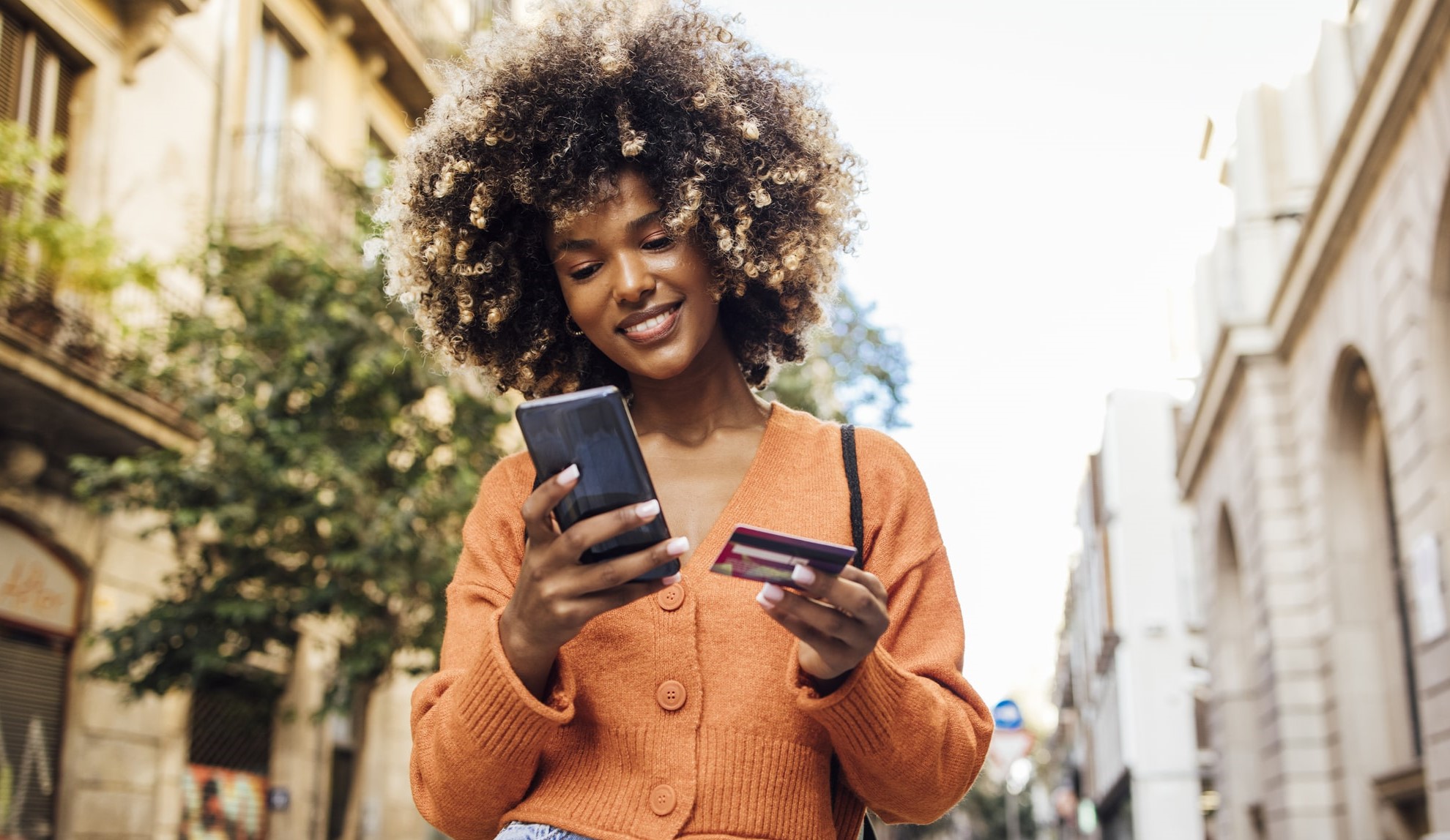 smiling woman holding phone smiling woman holding phone