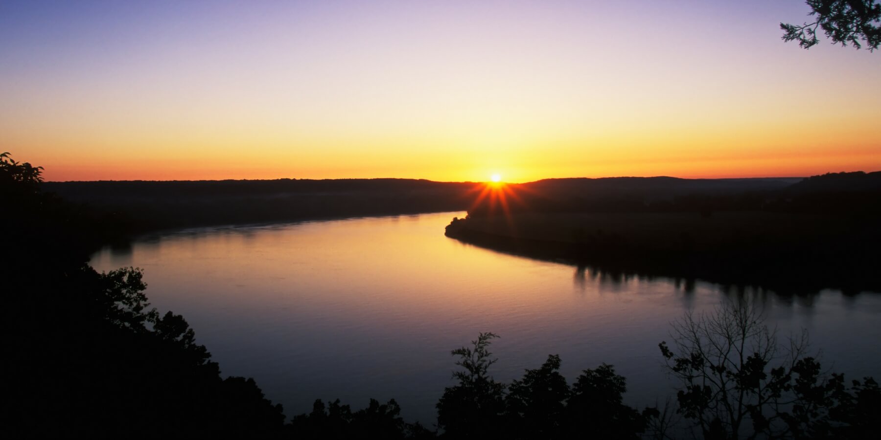 Sun low on horizon reflecting on water Sun low on horizon reflecting on water