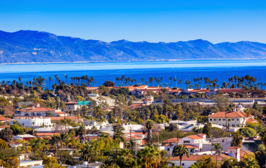 Red-roofed buildings with palms and ocean Red-roofed buildings with palms and ocean