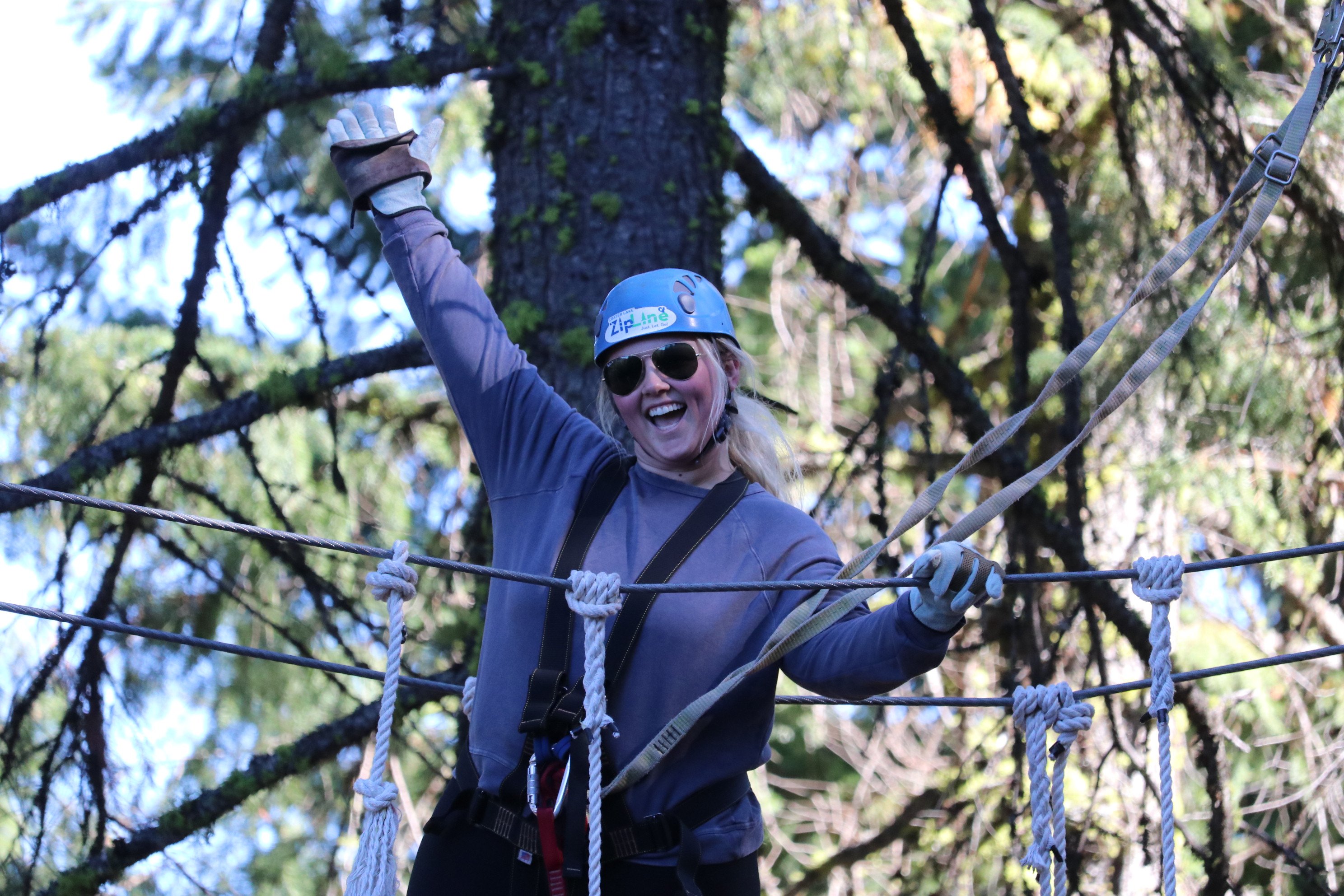 RRT travelers Annie B smiles in tree after hang gliding RRT travelers Annie B smiles in tree after hang gliding