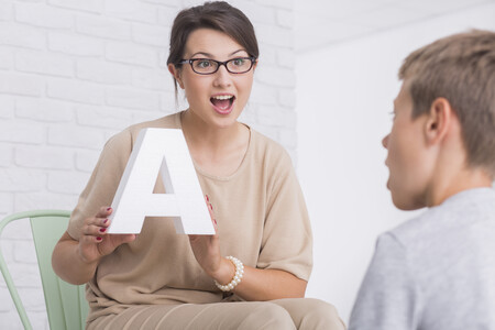 Speech-language pathologists working with a student Speech-language pathologists working with a student