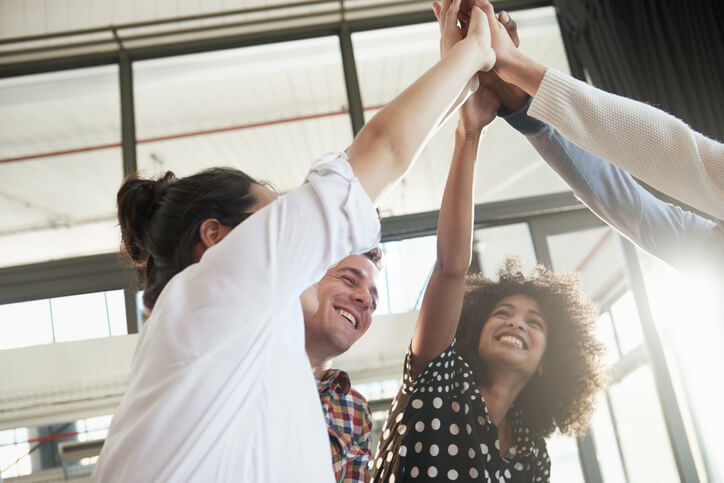 Young professionals high fiving each other Young professionals high fiving each other
